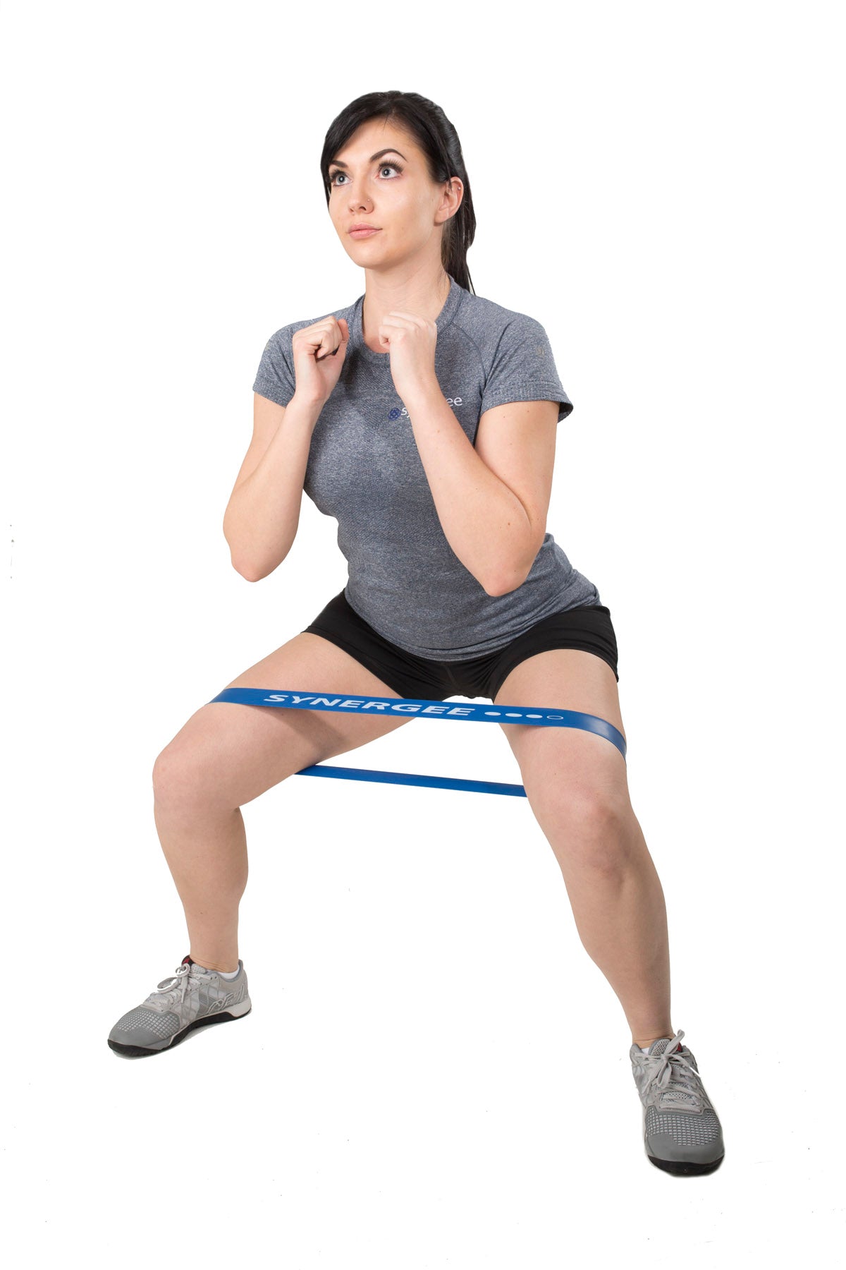Resistance band workout with Synergee resistance band, featuring a woman in a squat position.