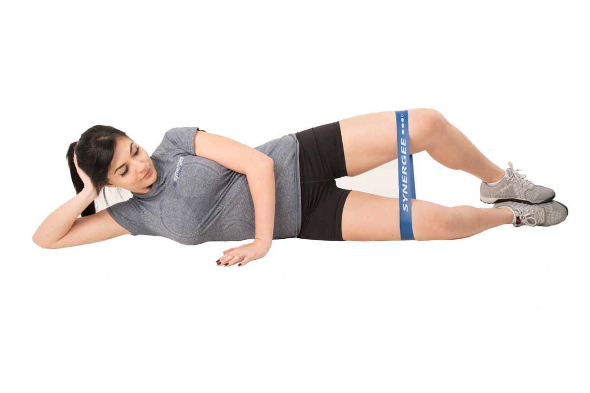 Resistance band workout featuring a woman performing side leg lifts with a blue band.