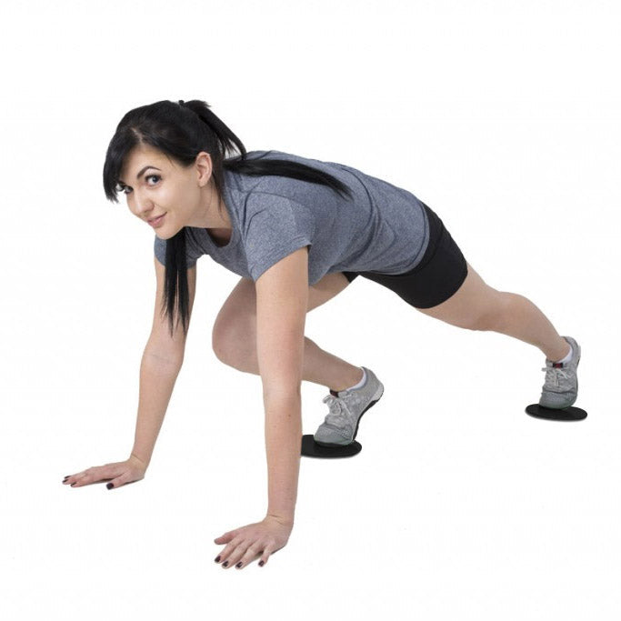 Fitness Sliding Discs used by a woman in a workout, demonstrating mountain climber exercise.