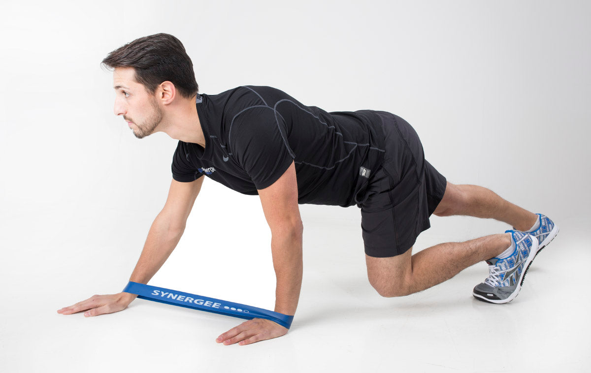 Resistance band for strength training, used by a man in a black shirt performing an exercise.
