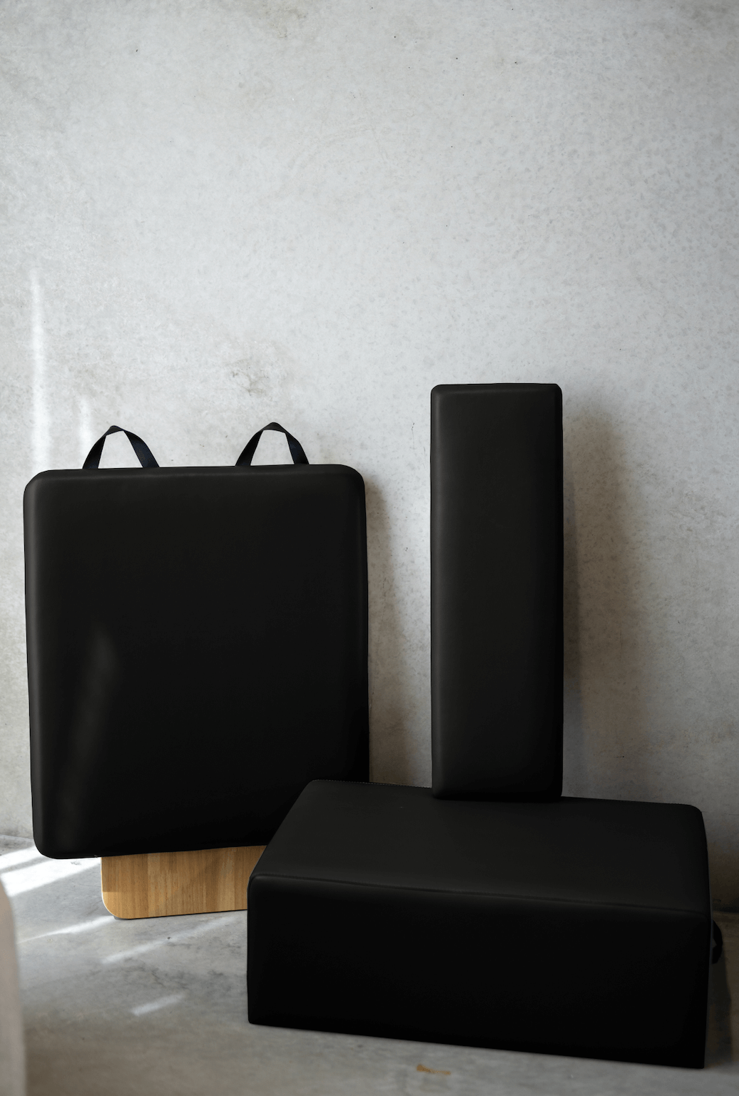 Black yoga block set featuring three different shapes for versatile workouts.