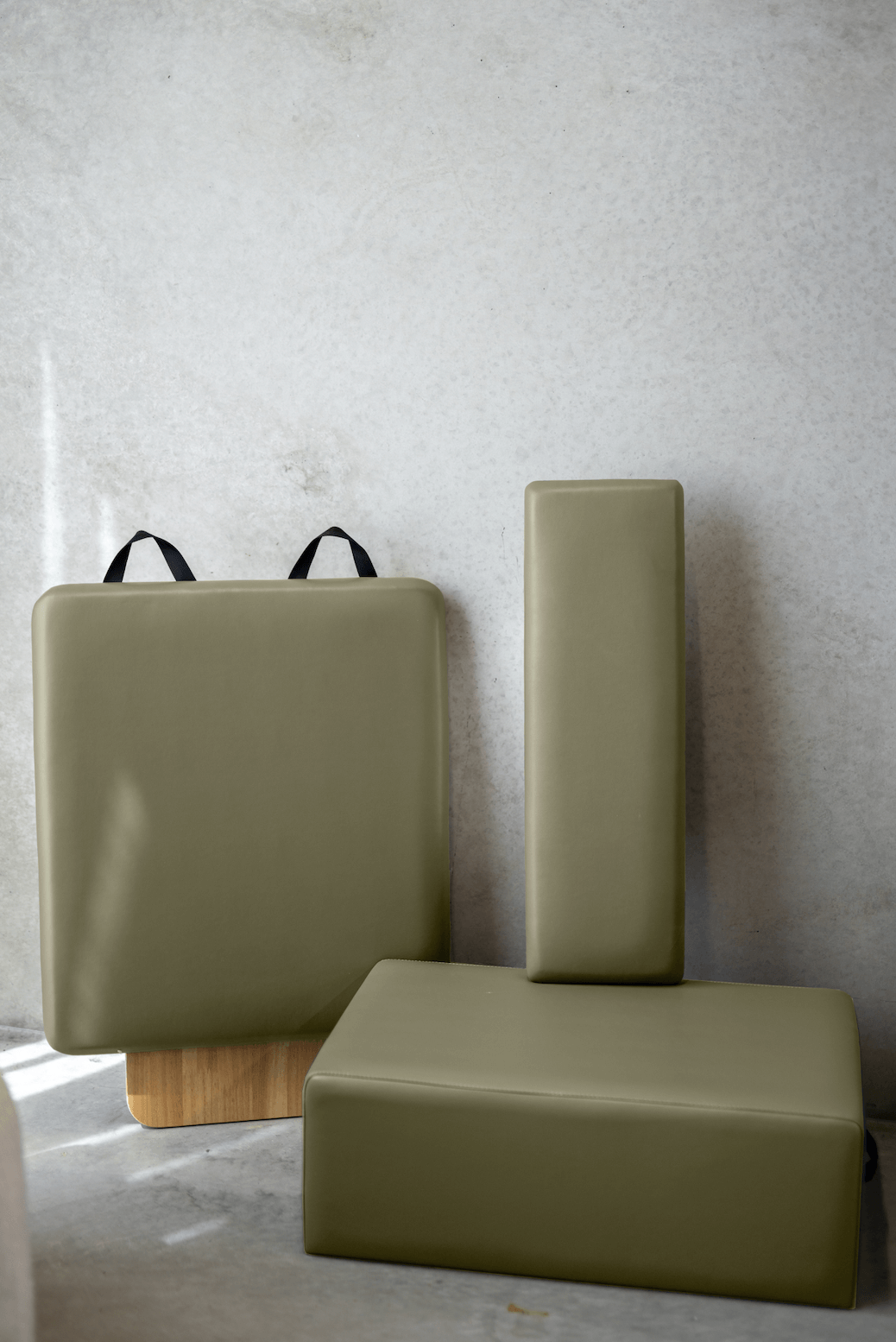 Olive green yoga block set featuring a square block, a rectangular block, and a vertical support.