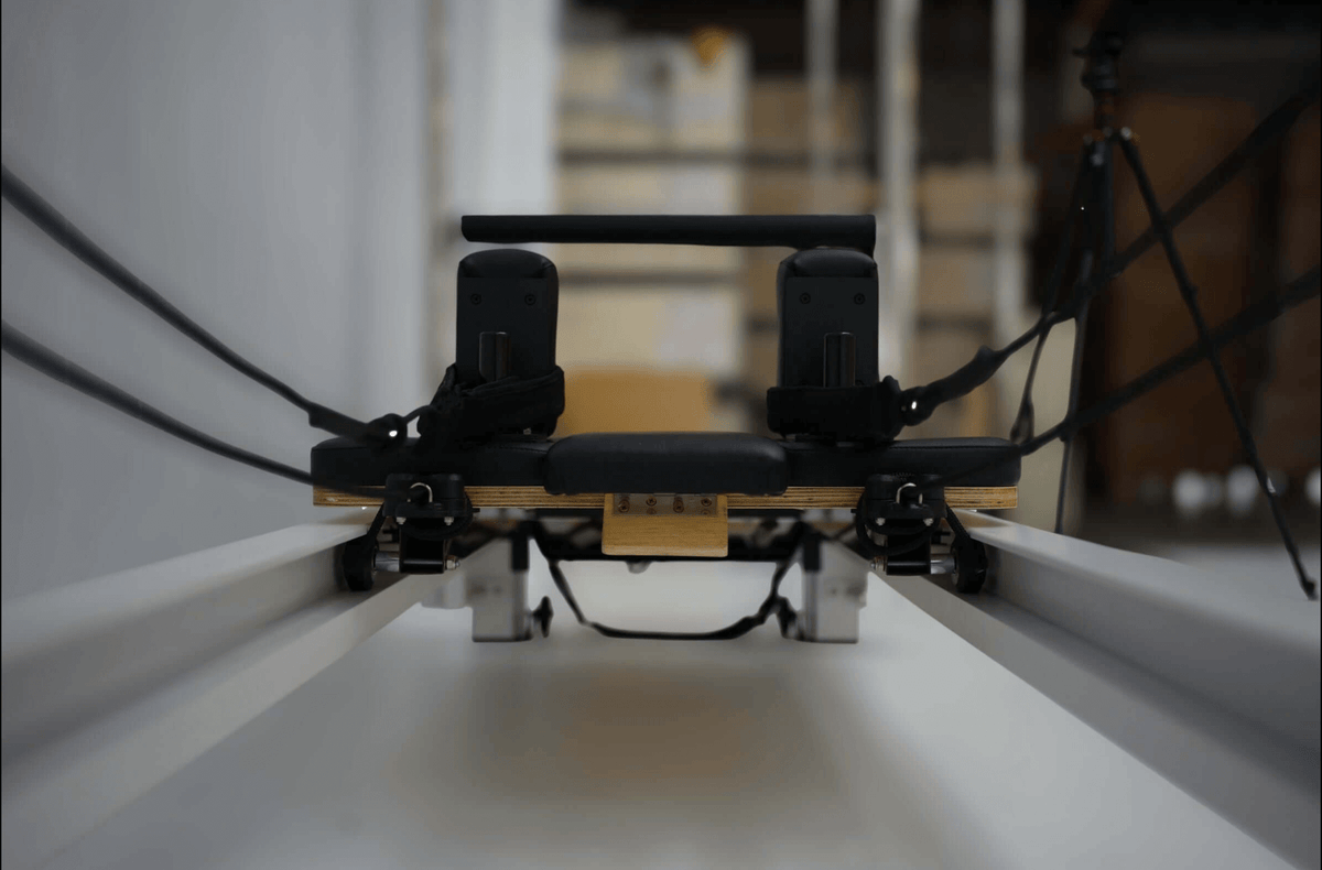 Rowing machine with adjustable seat and resistance bands for effective workouts.