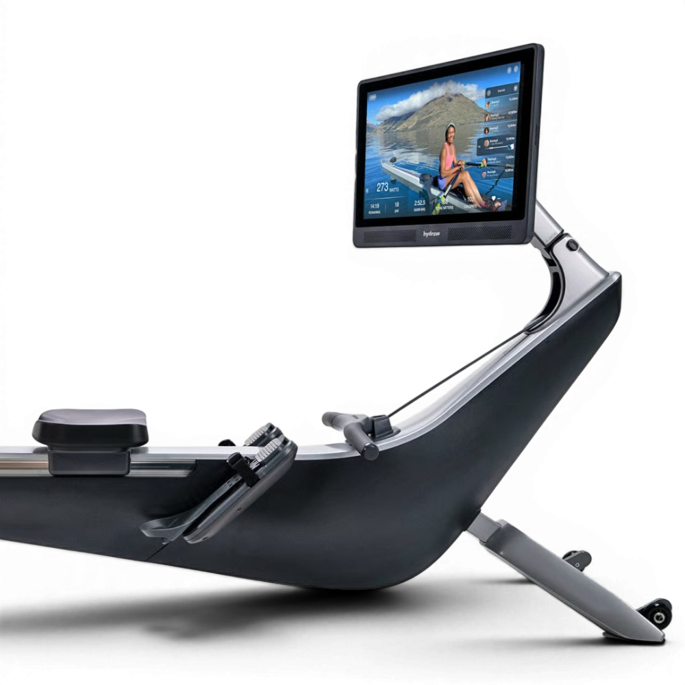 Rowing machine with a large display screen showing a scenic workout environment.