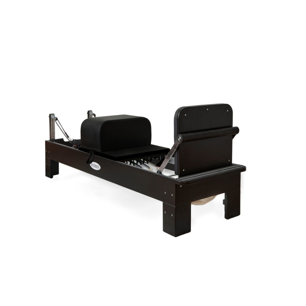Pilates reformer with a sleek black design and adjustable components for versatile workouts.