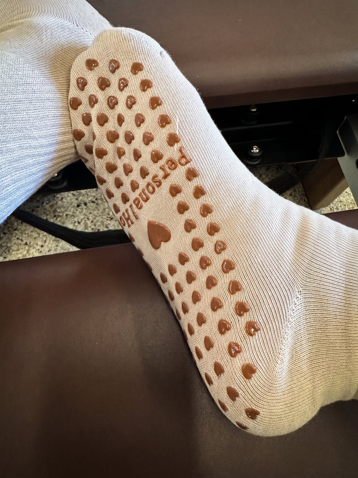 Personalized socks with heart-shaped grips on the sole, perfect for comfort and style.