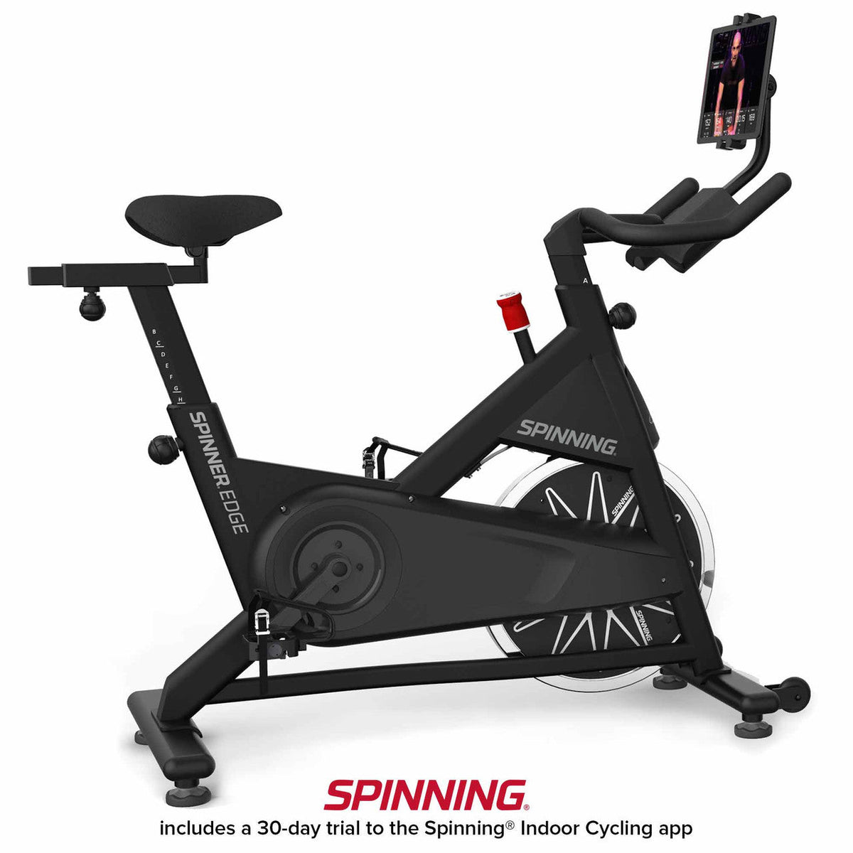 Spinning indoor cycling bike with adjustable seat and tablet holder for workouts.