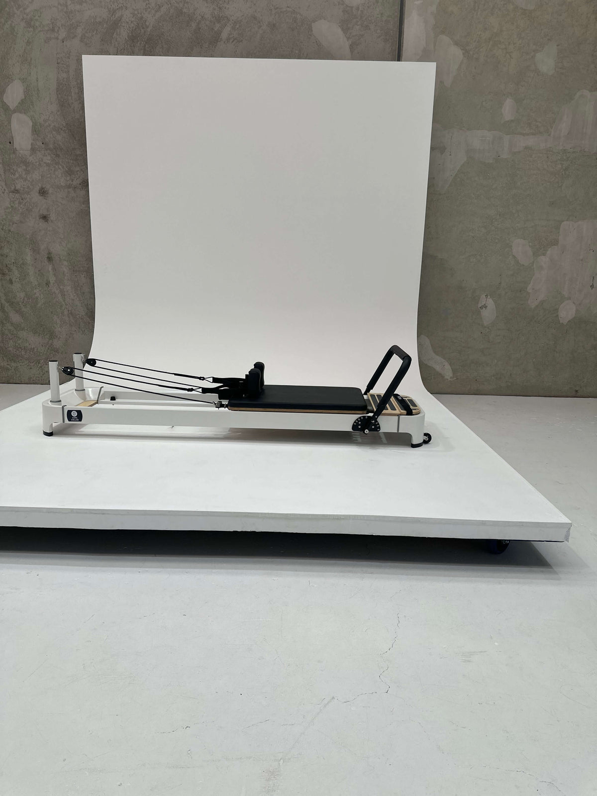 Pilates reformer machine with a sleek design and adjustable resistance features.