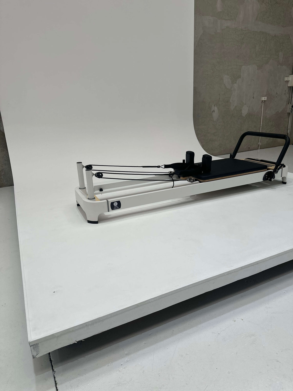 Reformer Pilates machine with adjustable resistance and sleek design.
