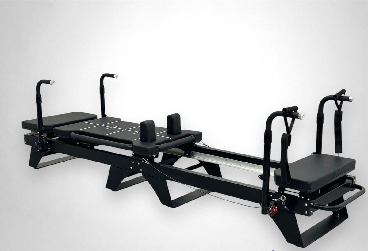 Reformer Pilates machine with adjustable resistance and padded surfaces for comfort.