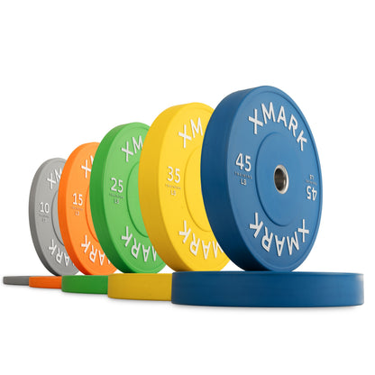 XMark weight plates in various colors and weights, including 45 lb blue and 25 lb green.