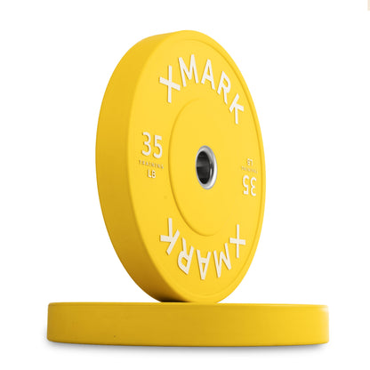 XMark 35 lb yellow rubber weight plate with a smooth finish and clear markings.