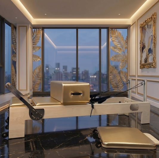 Pilates reformer with a gold box in a luxurious studio setting featuring large windows.