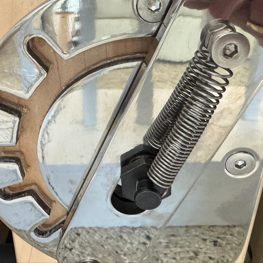 Heavy-duty gear mechanism with a shiny metal finish and spring detail.