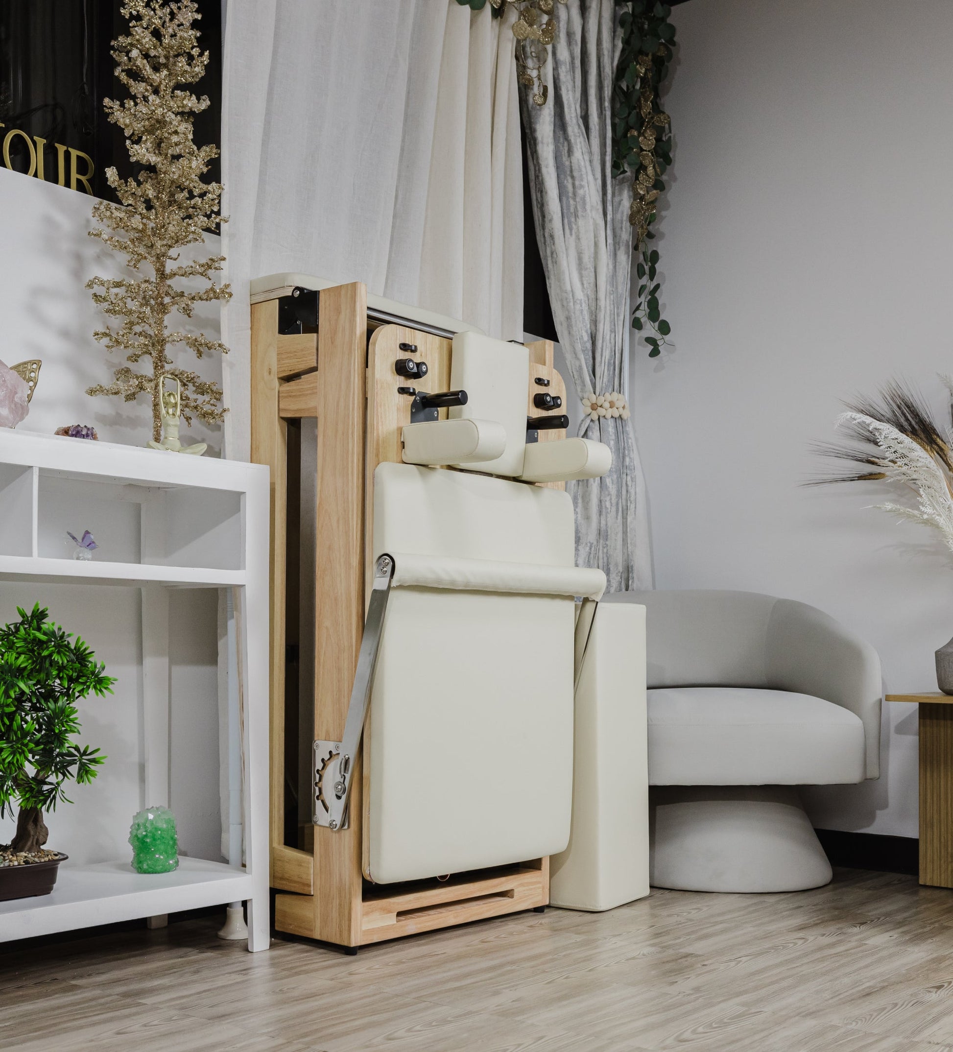 Wooden Pilates reformer with cream upholstery, designed for home workouts.