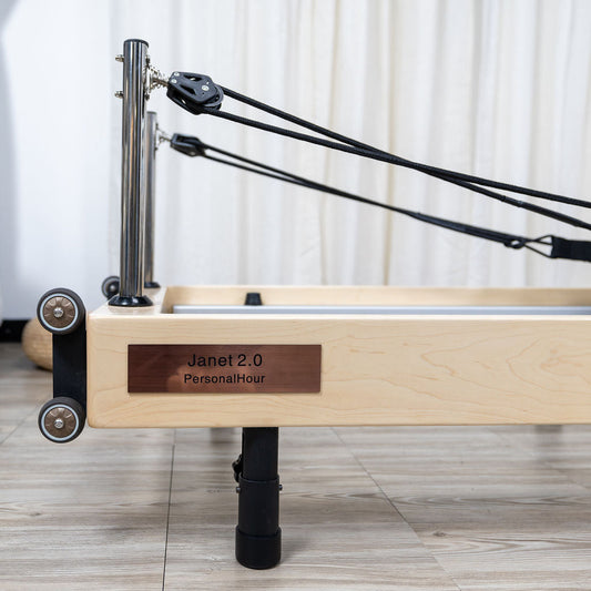 Jahot 2.0 reformer with adjustable resistance and wooden frame for Pilates workouts.
