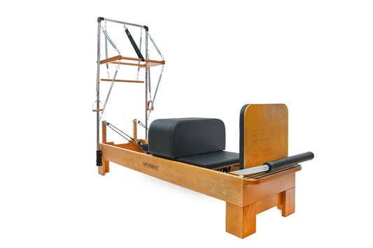 Pilates reformer with wooden frame and black padded carriage for effective workouts.