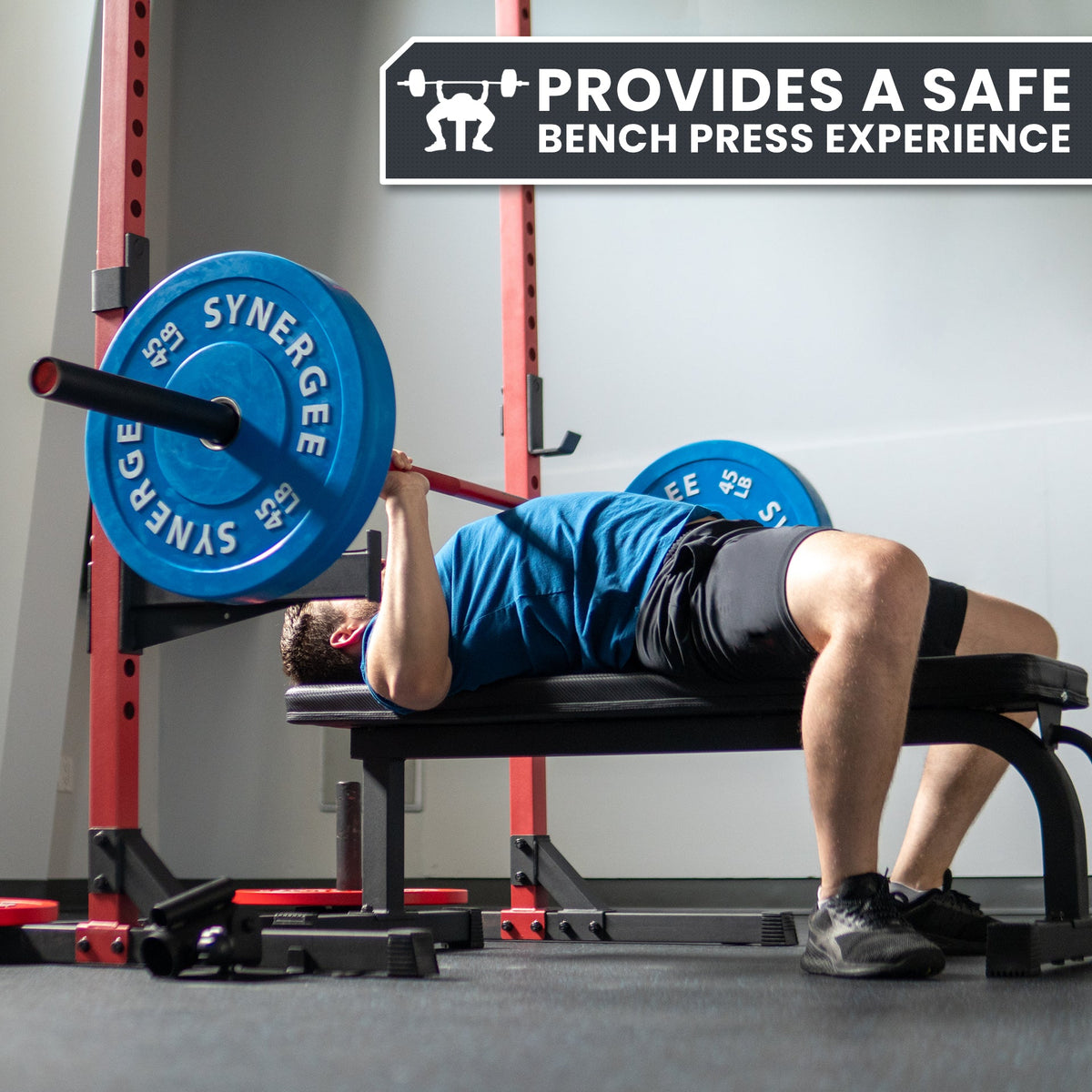 Synergee bench press setup with weights, providing a safe workout experience.