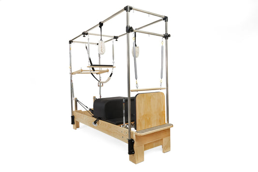 Pilates reformer with wooden frame and adjustable straps for versatile workouts.